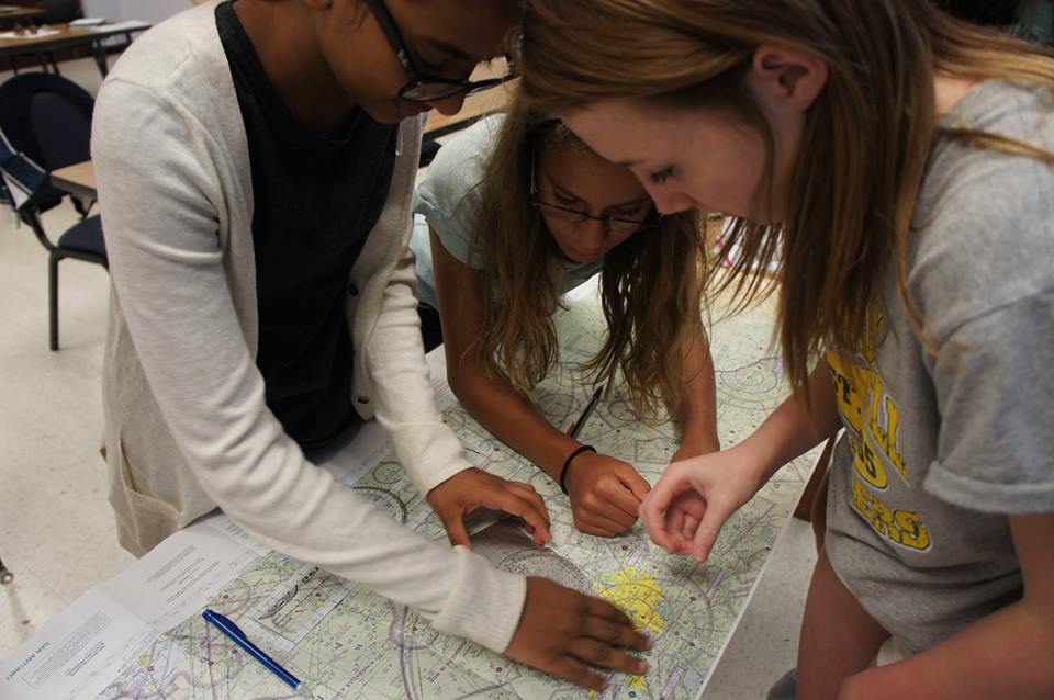 Girls working with maps